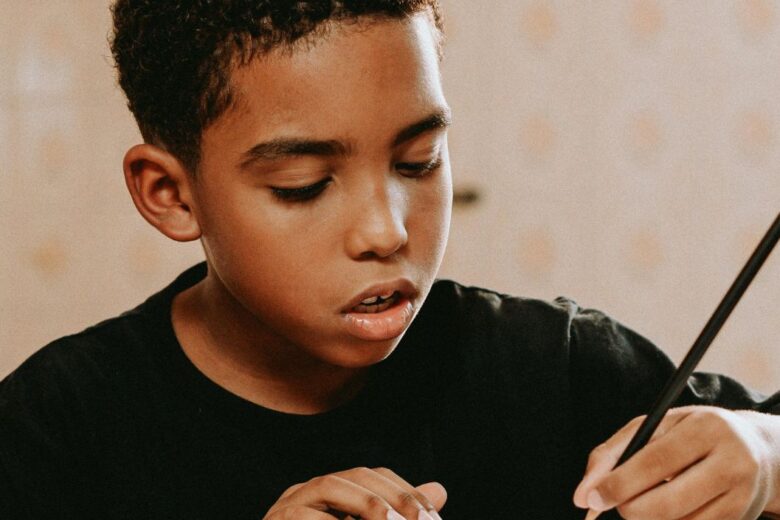 Boys at at a table writing