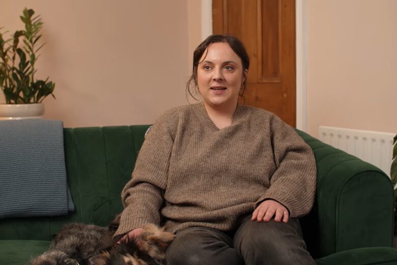 Jade, Foster Carer, sat in her home with two dogs